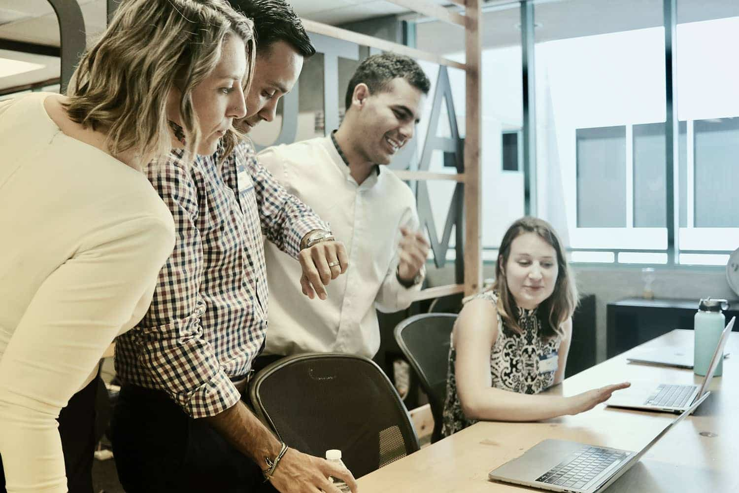 A group of people meeting with their laptops